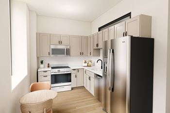 A modern kitchen with a black refrigerator and stainless steel appliances.
